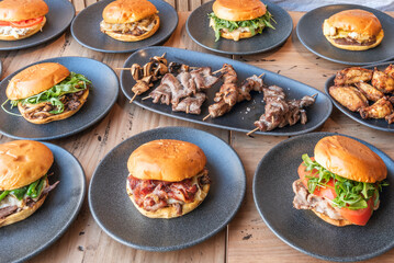 Gourmet burger with a chef's secret blend, melted fontina cheese, mountain tomatoes, and Trocadero lettuce on a brioche bun