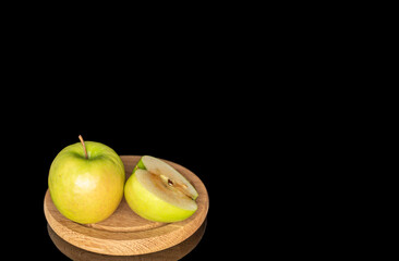 Juicy green apples isolated on black background, close-up.