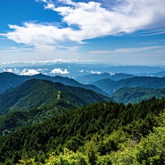 Forested mountain ranges cascade under a bright sky with puffy clouds, offering a serene and expansive natural vista