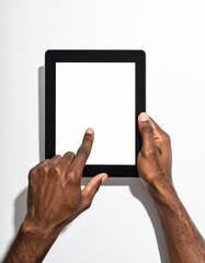 Dark-skinned hands touch a blank tablet screen against white. Minimalist. Forearms visible, pointing finger. Isolated. Tech demo display