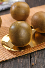 Luo Han Guo Monk Fruit on Golden Plate - Traditional Chinese Medicine Ingredient Studio Photography