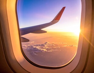 Plane view capturing a wing in warm light over soft clouds, seen through a window. The sun sets on the horizon in shades of orange