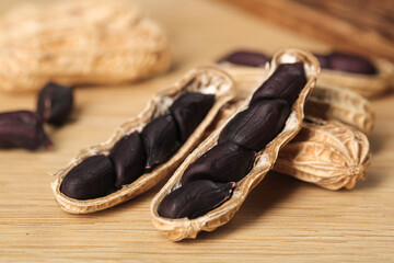 Black Selenium-Enriched Peanuts from Yunnan Province - Nutritious Specialty Grains and Cereals on Wood Background