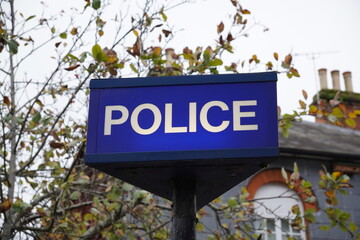 Police Station sign in small English town. Law enforcement and crime