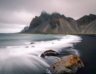 Dramatic black sand beach meets rugged mountains