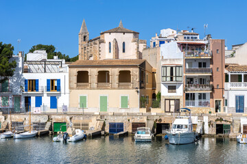 Colorful houses in Portocolom fishing village on Mallorca island with boats holiday by the sea in Spain
