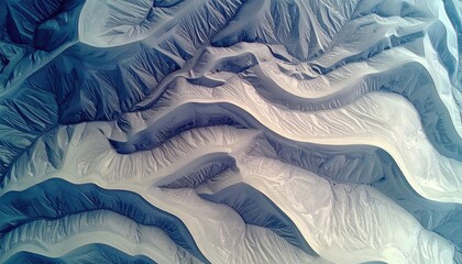 High-angle view of sculpted, pale blue-gray canyons