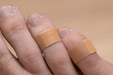 Toes covered with medical dressing, minor foot injuries plaster