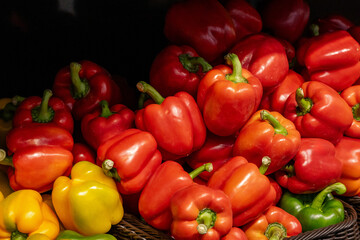 Vibrant assortment of fresh bell peppers in red, orange, and yellow hues organized attractively. Highlights the natural beauty and freshness of produce, perfect for concepts involving healthy eating.