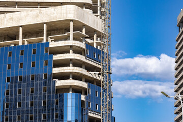 Installation double glazed windows on high-rise building. Building construction, glazing facade of new building. Mount insulated glass panels on facade of high-rise building © NastyaPhoto
