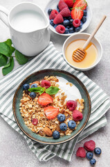 Granola bowl with yogurt, berries, and mint for breakfast
