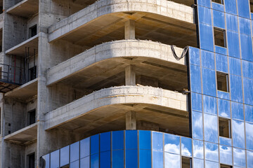 Installation double glazed windows on high-rise building. Building construction, glazing facade of new building. Mount insulated glass panels on facade of high-rise building © NastyaPhoto