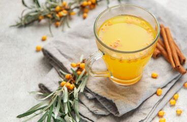 Sea buckthorn hot drink with cinnamon sticks and berries