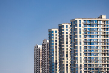 Front view of a white modern skyscraper perfect symmetry with blue sky and copy space. Architecture background concept