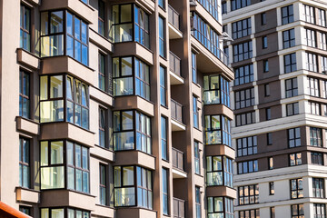 Modern luxury residential flat. Modern apartment building on a sunny day. Apartment building with a blue sky. Facade of a modern apartment building.