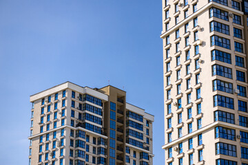 Part of Modern residential apartment with flat building exterior. Detail of New luxury house and home complex. Fragment of City Real estate property and condo architecture. Copy space. Blue sky