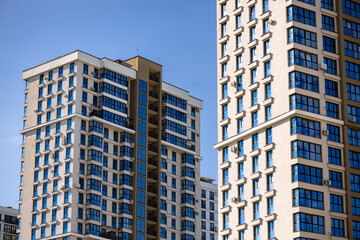 Part of Modern residential apartment with flat building exterior. Detail of New luxury house and home complex. Fragment of City Real estate property and condo architecture. Copy space. Blue sky