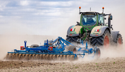 Farmer in tractor preparing land for sowing. Farmer in tractor preparing land with seedbed cultivator