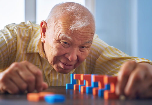 Senior focused on a jigsaw puzzle for mental exercise and therapy