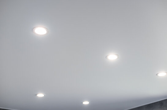 Ceiling with evenly spaced recessed lighting fixtures.