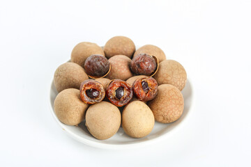 Fresh Yunnan Longan Fruits on White Plate - Asian Tropical Fruit with Peeled Examples Showing Flesh and Seeds