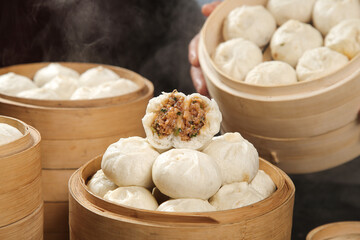 Traditional Chinese Xiaolongbao Steamed Dumplings in Bamboo Steamers with Meat Filling