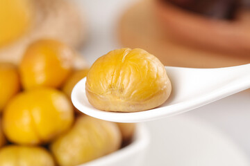 Peeled Roasted Chestnut on Spoon Close-up - Golden Brown Cooked Nut with Natural Texture