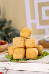 Deep Fried Tofu Puffs Stacked on Greens - Delicious Asian Vegetarian Food