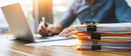 The professional workspace featuring organized paperwork and a focused individual.