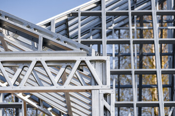 Fototapeta premium Light gauge steel framing system used for house construction. Wall to be clad with fibre cement board. Metal frame of a new modern house. Copy space