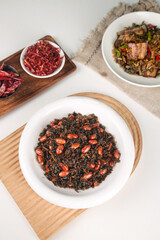 Traditional Homemade Plum Sauce with Dried Chilies and Pomegranate Seeds on Wooden Serving Boards