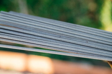 Welding electrode in the hands of a person at work. Profession: welder, working specialty, equipment, tools for welding metals.