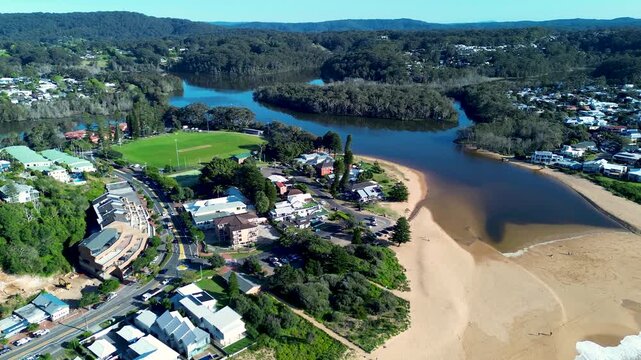 Drone aerial landscape of Avoca Beach lake lagoon and sandy channel inlet with surrounding coastal residential housing and town centre main street Central Coast NSW Australia travel tourism vacation