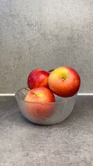 bowl of apples on grey background