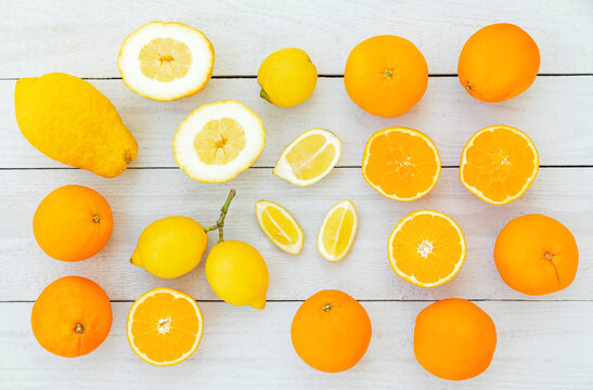 Assorted fresh citrus fruits orange lemon and cedro arranged on white table