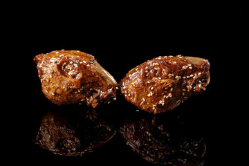 Chinese Spicy Stewed Rabbit Head Dish with Sesame Seeds - Traditional Shuangliu Cuisine on Black Background