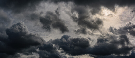 Dark dramatic sky. Gloomy stormy cloudscape. Widescreen panoramic photo of a natural moody cloud...
