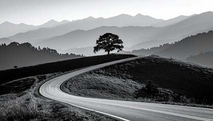 Winding road leading to a lone tree atop a hill, with misty mountains in the background