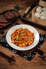 Chinese Dry Pot Stir-Fry with Smoked Bacon and Asparagus on Rustic Wooden Table