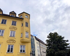 An amazing combination of architectural styles from different eras is noted by a traveler on the streets of Munich on a warm summer day.