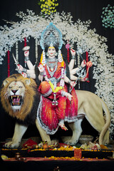 Goddess Durga with lion statue, Hindu goddess Durga idol, Navratri festival Durga maa, Divine Durga mata sculpture stock photo.