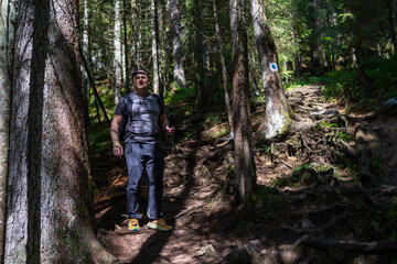 Hiker filming on forest trail