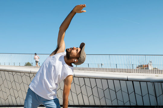 Runner stretching outdoors at MAAT Lisbon for urban fitness