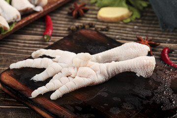 Fresh Raw Chicken Feet with Spices on Slate Board - Asian Cuisine Ingredient