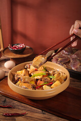 Marinated Air-Dried Chicken Specialties Ready to Eat with Chopsticks in Traditional Wooden Bowl