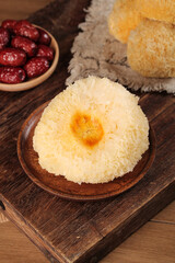 Glutinous Rice Dessert with Silver Ear Fungus and Red Dates on Wooden Board