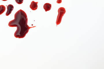 Droplets of blood spots on a white background. Top view with copy space