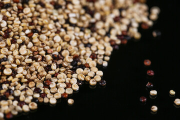 Mixed Quinoa Grains and Beans on Black Background - Healthy Superfood Ingredients