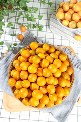 Fresh Golden Kumquats in Wicker Basket - Sweet Crisp Citrus Fruits on Kitchen Table