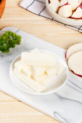Fresh White Peeled Yam Slices on Kitchen Cutting Board with Parsley Garnish